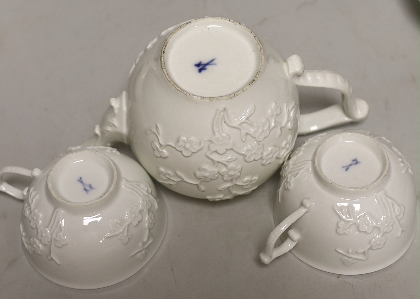 A 18th century Meissen teapot and two teacups and saucers, c.1740